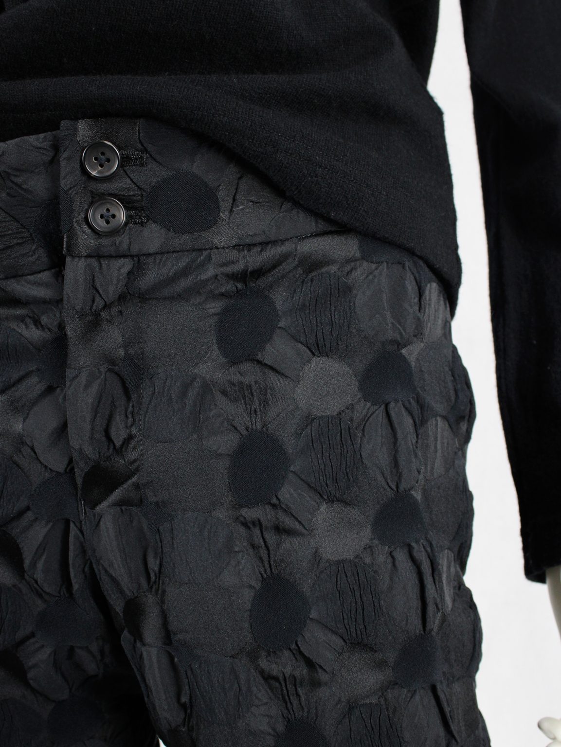 Issey Miyake black trousers with the fabric manipulated into different circles