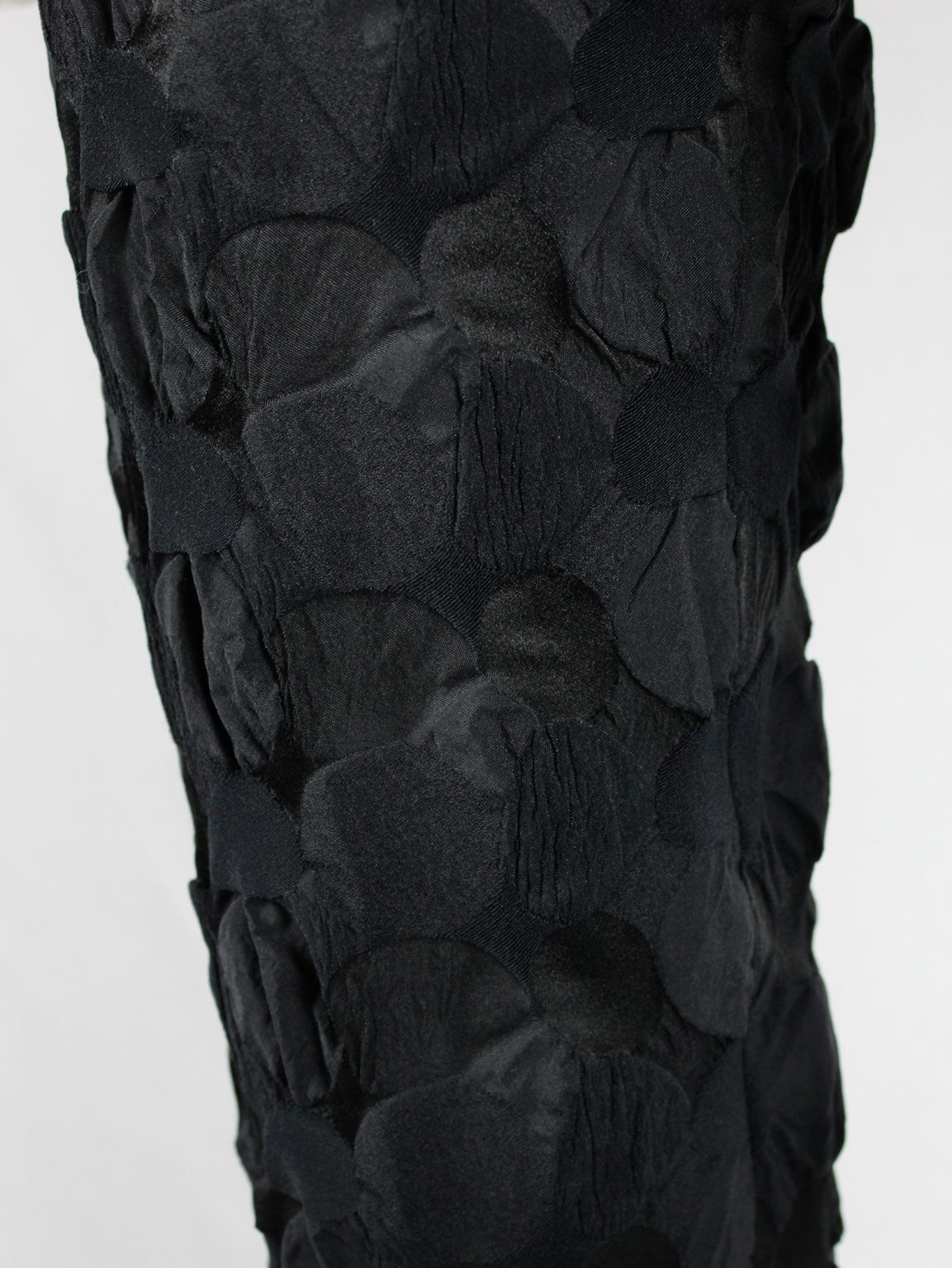 Issey Miyake black trousers with the fabric manipulated into different circles