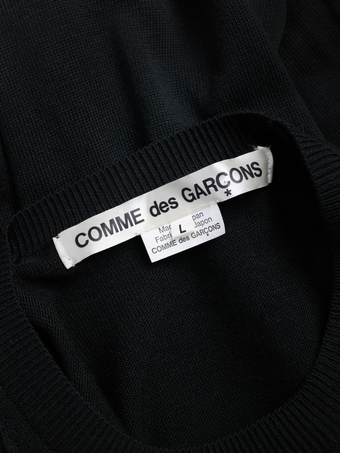 Comme des Garçons black knit top with long drooping strips — spring 2015