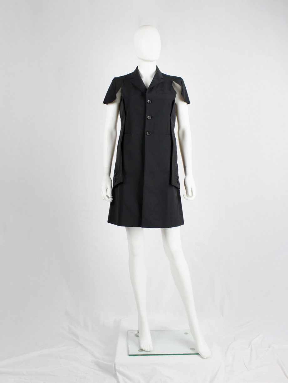 Comme des Garçons black deconstructed jacket with cut off sleeves sewn on the sides — spring 2012