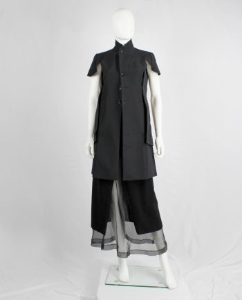 Comme des Garçons black deconstructed jacket with cut off sleeves sewn on the sides — spring 2012
