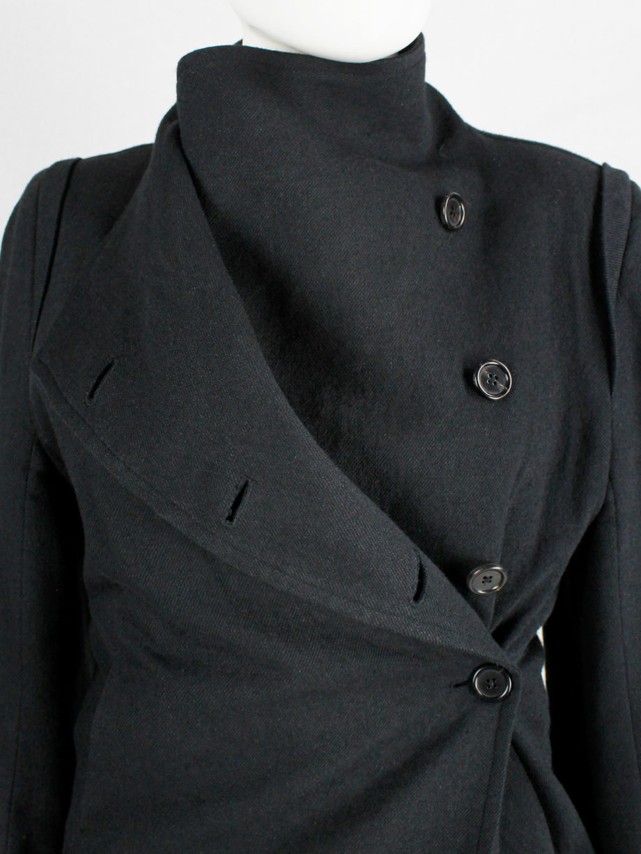 Ann Demeulemeester black coat with standing neckline and asymmetric button closure — fall 2010