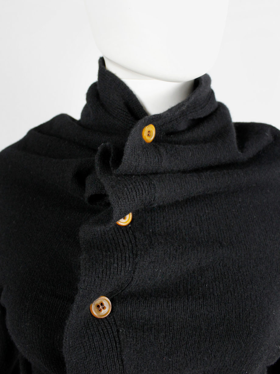 Comme des Garçons black circular cardigan with orange buttons and cutaway front — fall 2002