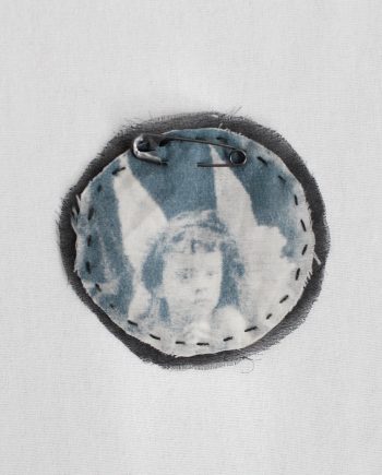 Ann Demeulemeester round pin brooch with cherub print — fall 2005