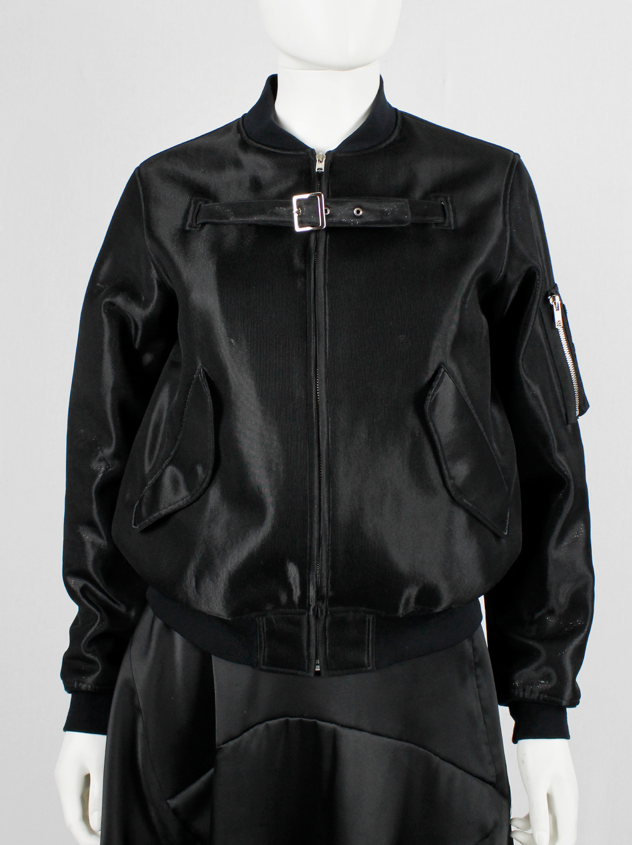 Noir Kei Ninomiya black bomber jacket with belted strap across the ...