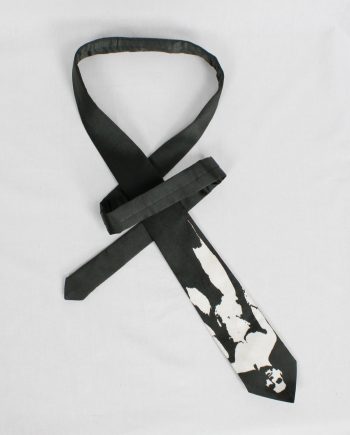 Christophe Coppens black tie with upside down bleached naked man in white