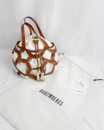 vintage Dirk Bikkembergs brown leather football bag with hexagonal cutouts over a white fabric bag